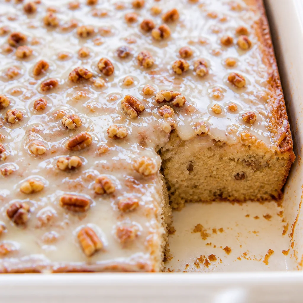 Delicious Pecan Praline Poke Cake with butter pecan and coconut pecan frosting