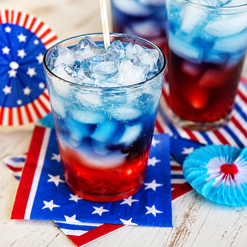 Delicious Red White and Blue Patriotic Punch Bowl with festive fruits for July 4th.