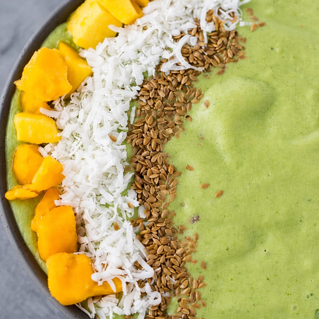 Coconut Mango Smoothie Bowl topped with vibrant fruits and coconut flakes.