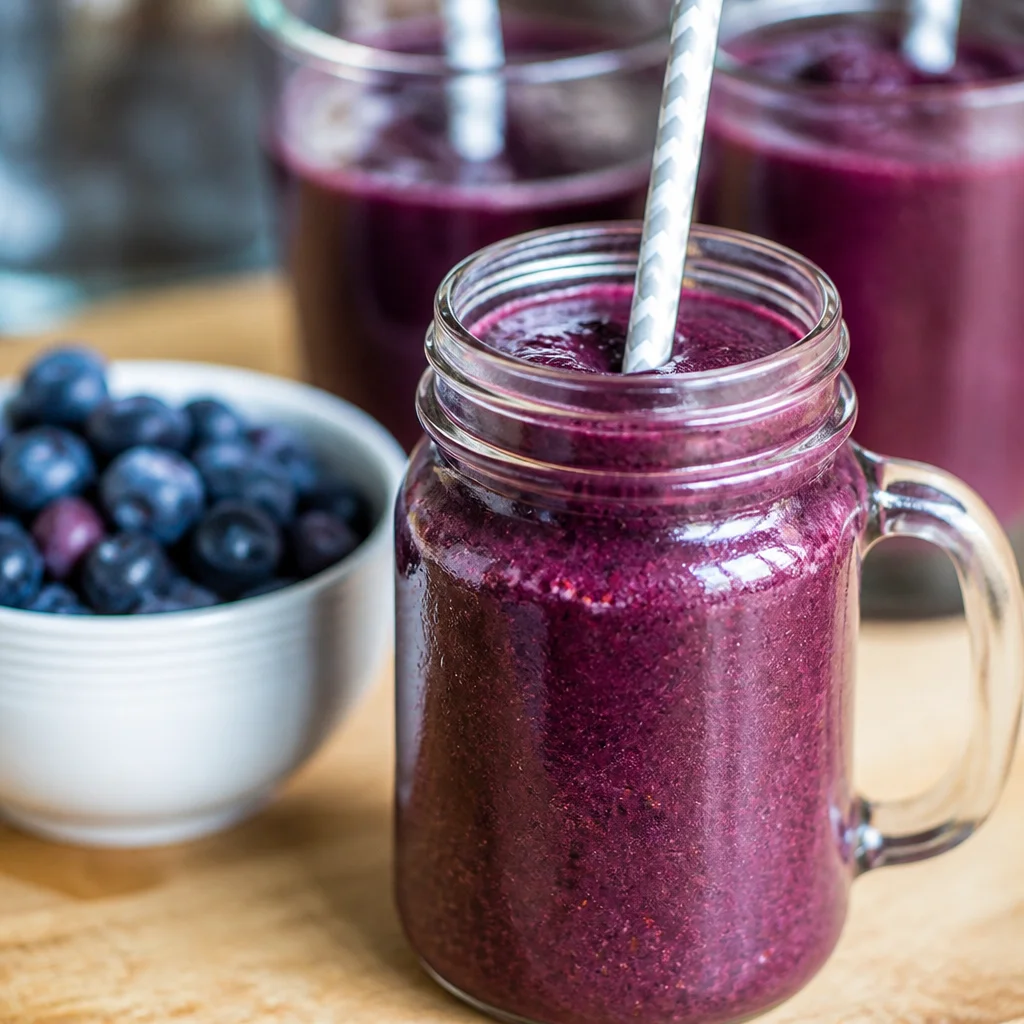 Blueberry Pomegranate Smoothie with yogurt and ice, a healthy fruit blend.