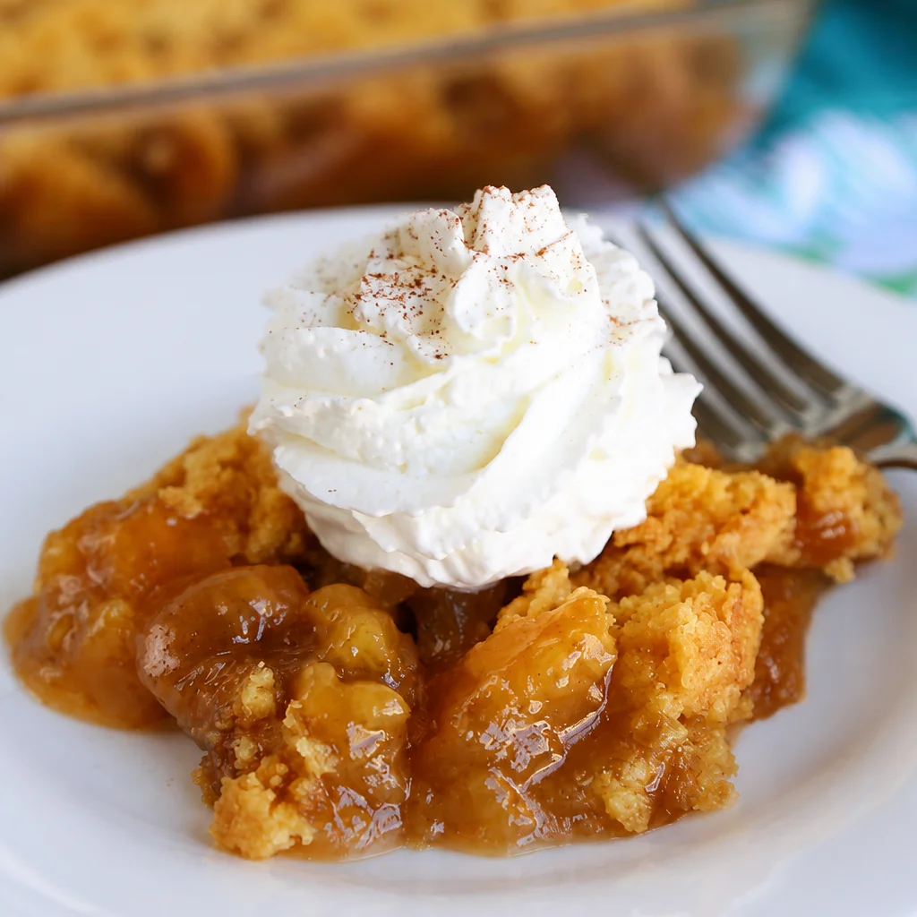 Delicious Caramel Apple Dump Cake topped with caramel sauce and a golden crust.