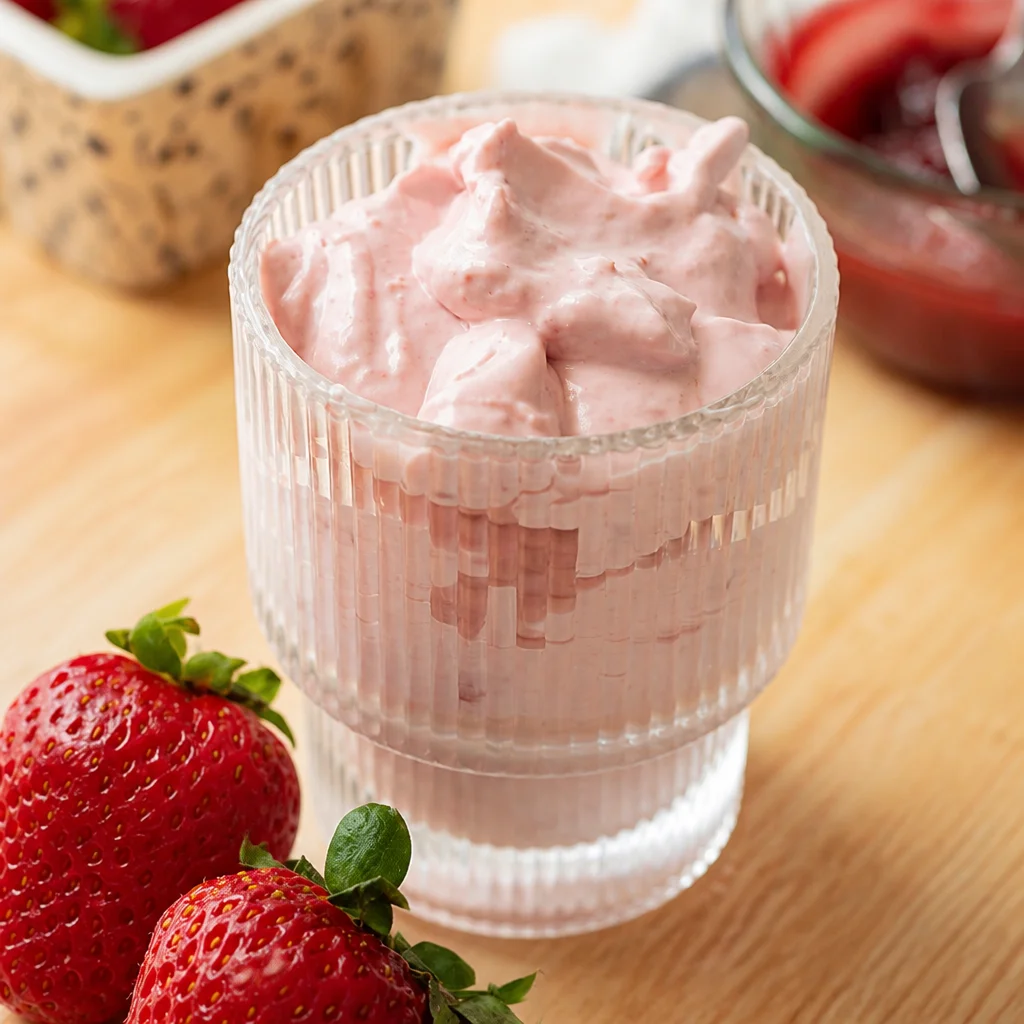 Creamy and fluffy homemade strawberry cold foam topping on iced coffee
